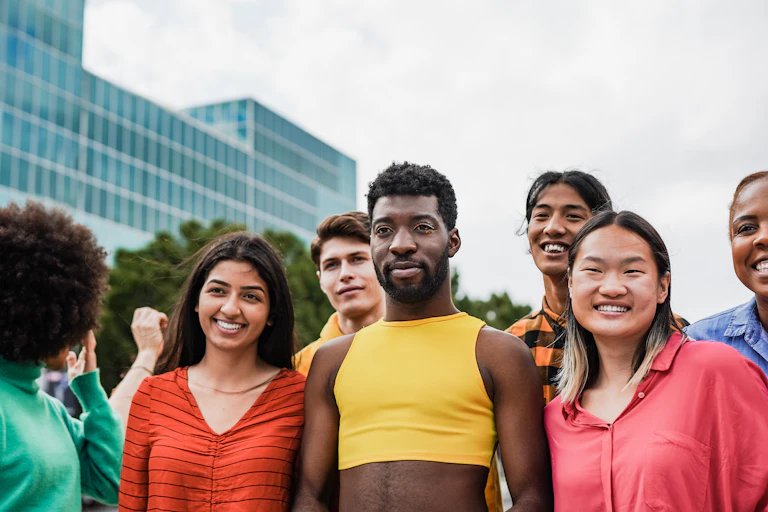 Group of people standing outside looking at camera
