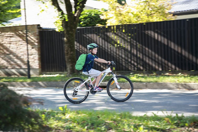 Boy biking to school.