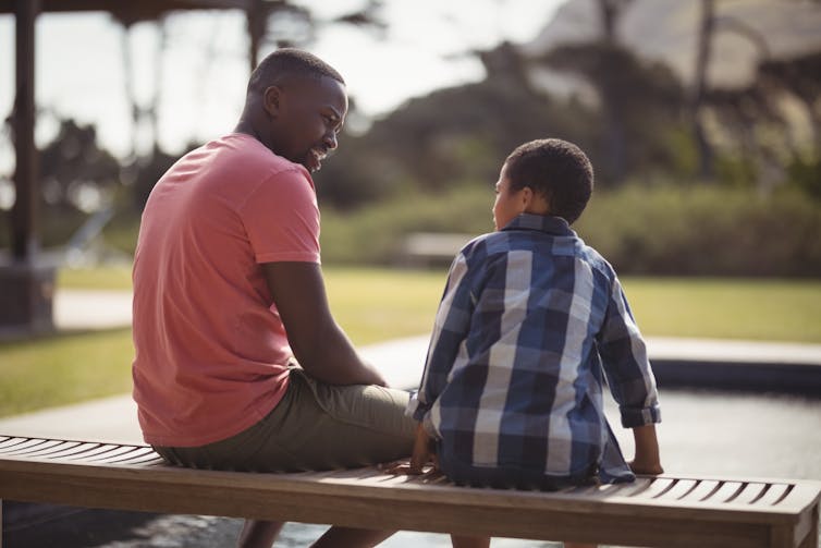 adult and child sit together