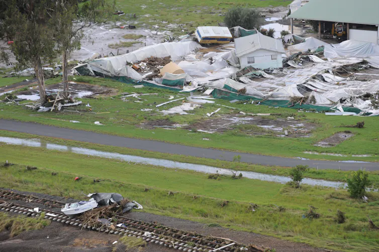 An aerial view of homes and cars carried away by floodwaters