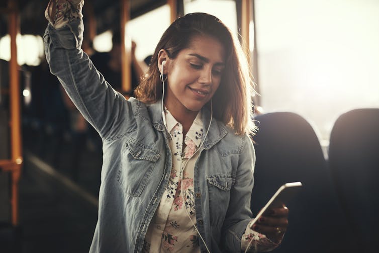 woman on bus with earphones