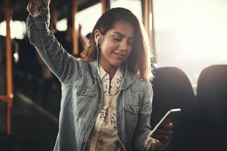 woman on bus with earphones