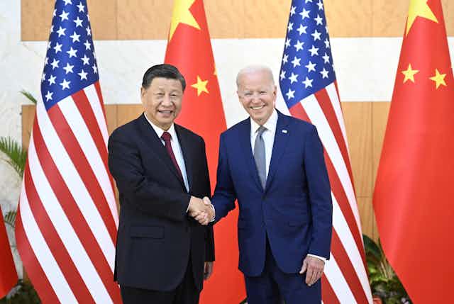 Chinese President Xi Jinping (L) greets his US counterpart Joe Biden before their meeting, one day ahead of the G20 Summit in Bali, Indonesia, 14 November 2022.