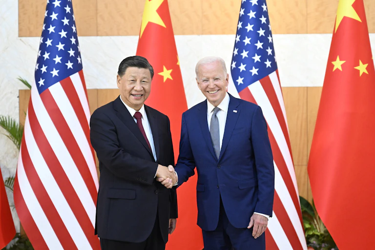 Chinese President Xi Jinping (L) greets his US counterpart Joe Biden before their meeting, one day ahead of the G20 Summit in Bali, Indonesia, 14 November 2022.