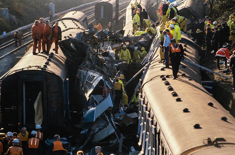Rescue workers climbing on the wreckage of the Clapham Junction train crash
