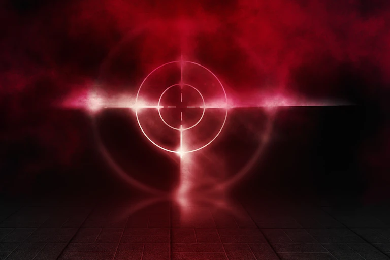 Conceptual image of a red target against a dark background with smoke around it.