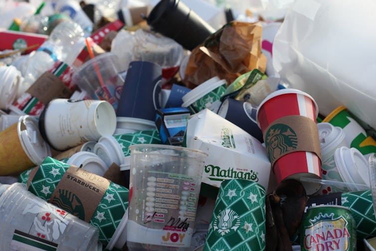 A pile of plastic cups and food packaging