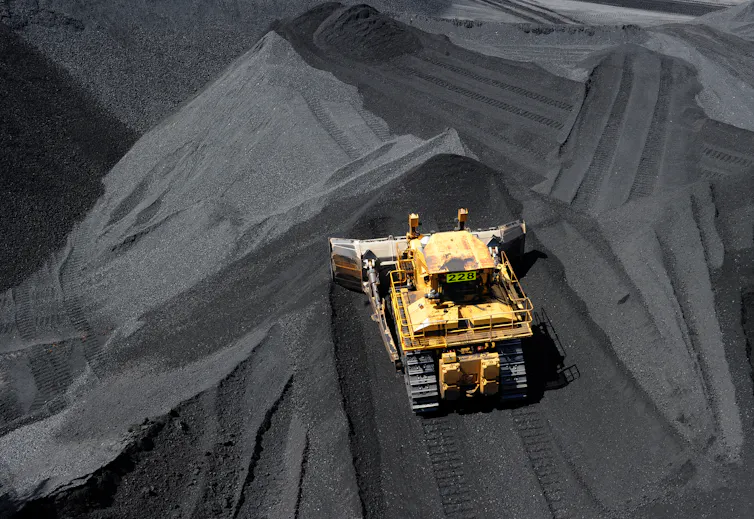 truck in piles of coal