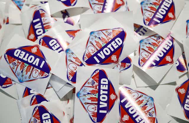 'I Voted’ stickers sit on a table at a polling place.