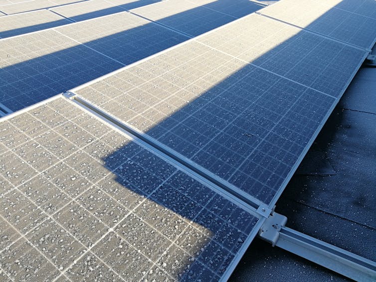 Rows of solar panels shaded by the row in front.