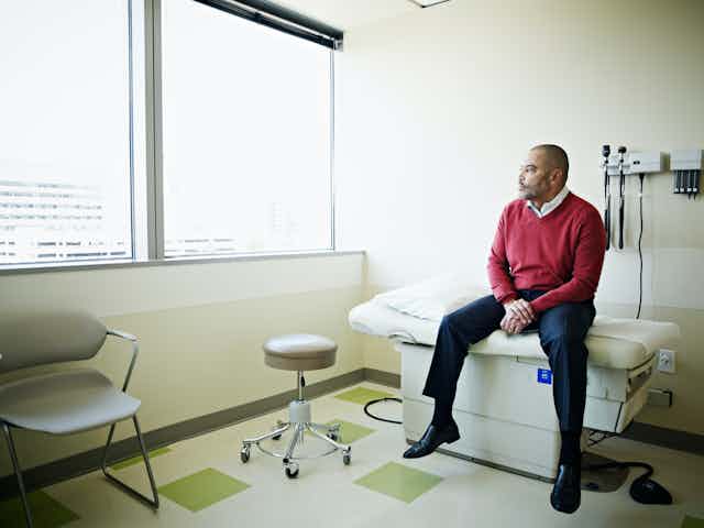 Patient sitting on exam table looking out of window