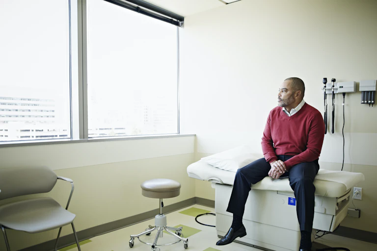 Patient sitting on exam table looking out of window