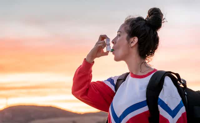 Woman using an inhaler