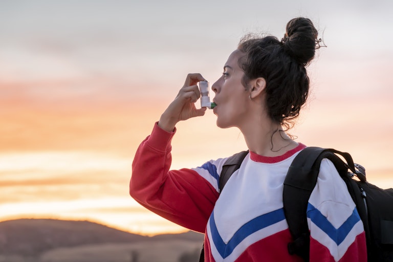 Woman using an inhaler