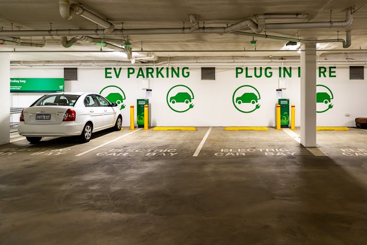 one car amid several empty EV charging spots