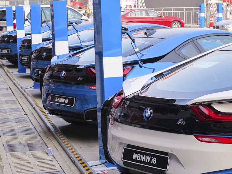 BMWs charging in a line