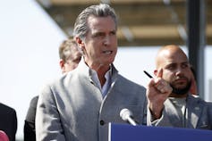 California governor Gavin Newsom gestures as he speaks at a press conference.