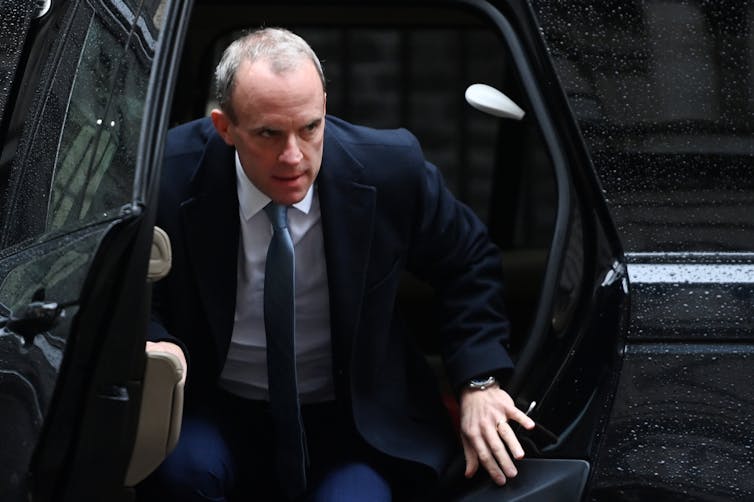 Dominic Raab getting out of a car.