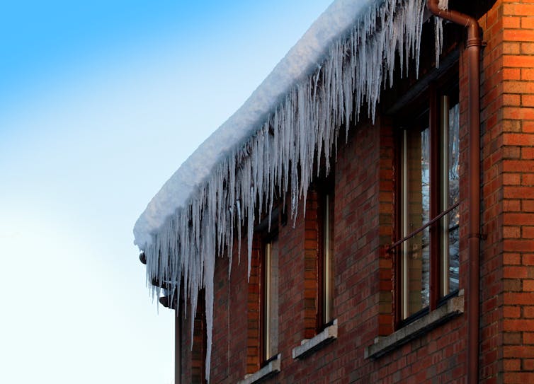 Icicles hang off a house roof