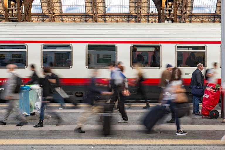 Commuters pass by in a train station