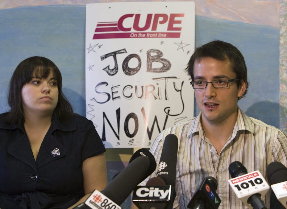 CUPE members seen in front of a sign that says Job Security Now.