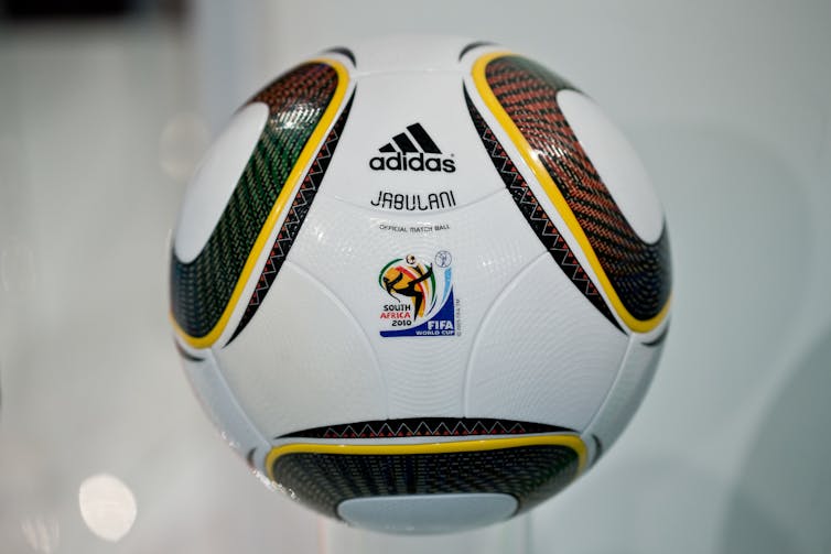 A soccer ball sitting on a stand.