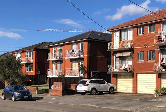 Row of red-brick apartment blocks