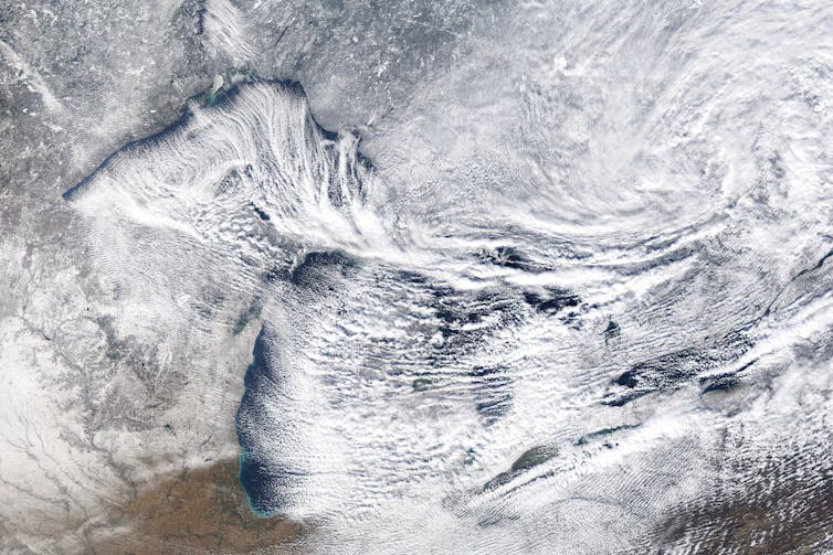 A satellite image shows wind blowing snow across Lakes Superior, Michigan, Huron, Erie and Ontario on Nov. 20, 2014