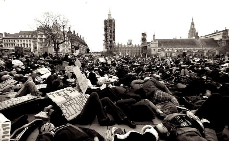 Many protesters lying down in Parliament Square