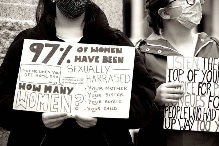 Two protesters holding signs