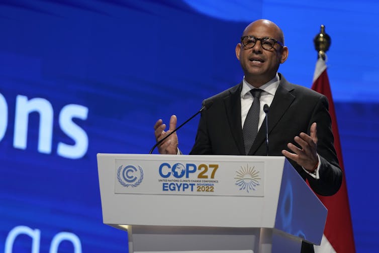 Man behind a COP27 podium