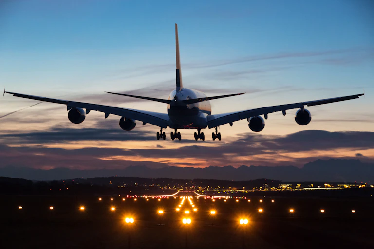 large airplane descends toward a runway