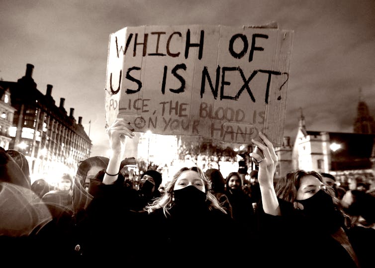 Protesters hold banners during a protest