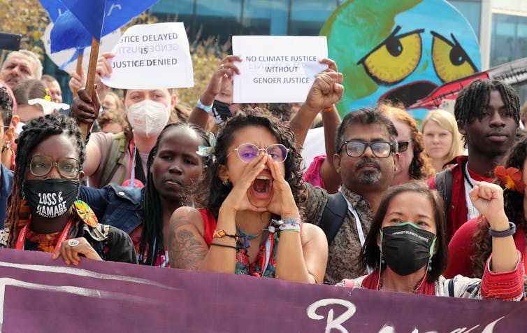 Protesters bearing signs and banners.