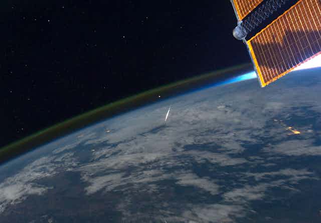 A photo taken from space shows a meteorite burning up in Earth's atmosphere.