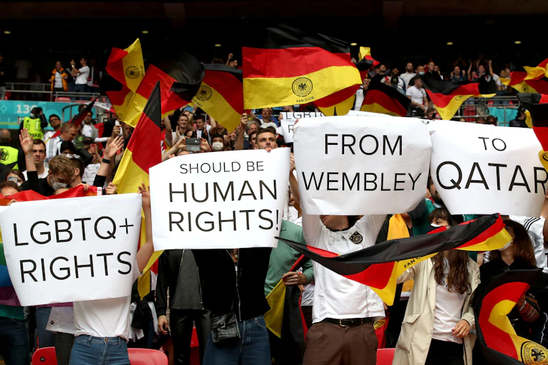 Fns hold up signs in support of lGBTQ+ rights.