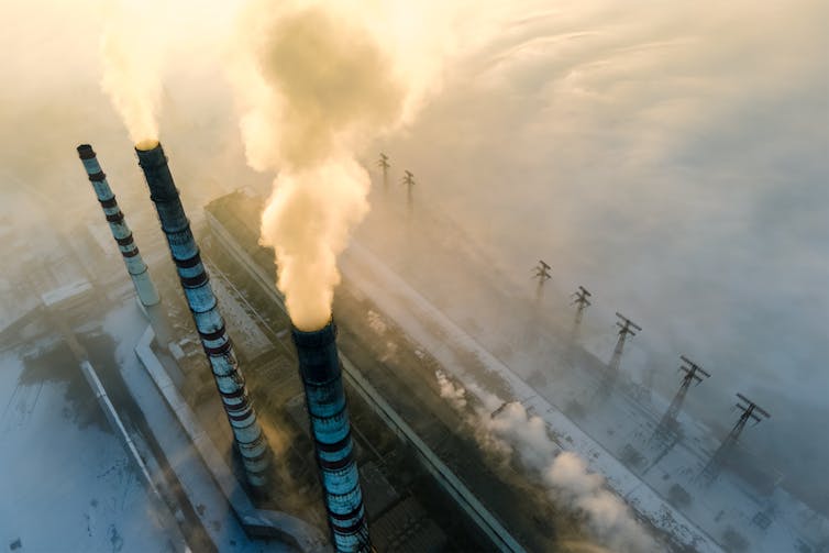 Three smokestacks on a power plant.