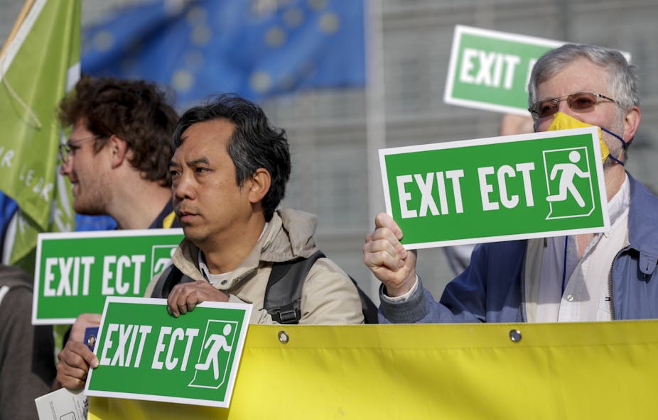 3 protestors holding green signs reading "Exit ECT".