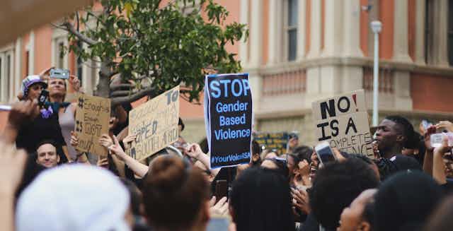 A protest with a placard that reads: stop gender based violence