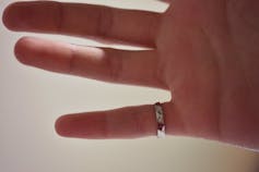 A ring seen on the pinky finger.