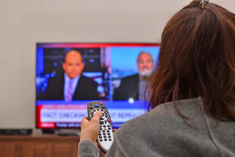 Person watching the news on TV