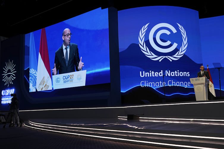 Man gives a speech behind a podium