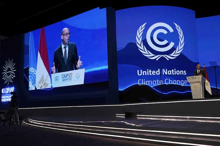 Man gives a speech behind a podium