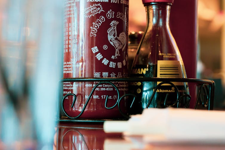 Sriracha bottle on restaurant table