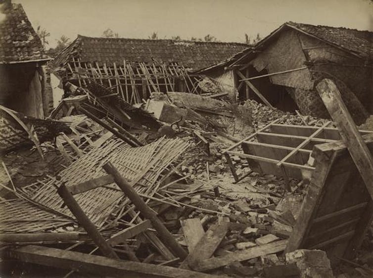 Sebuah foto sepia yang menunjukkan bangunan kecil yang runtuh sepenuhnya