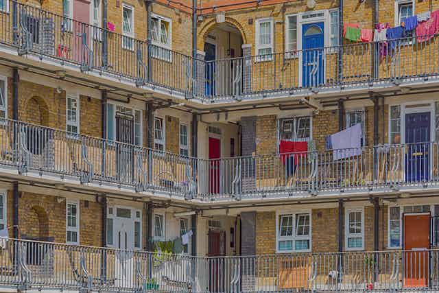 Balconies with washing and colourful doors on a housing estate.