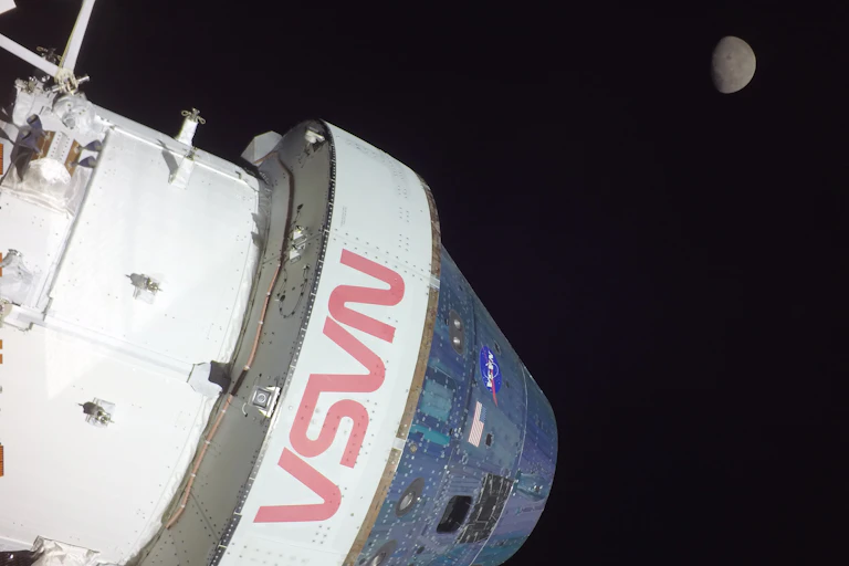 A camera mounted on the tip of one of the Orion capsule’s solar array wings captured this footage of the spacecraft and the Moon
