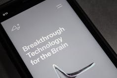 Website of Neuralink on an iPhone, grey screen with the words