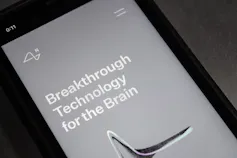 Website of Neuralink on an iPhone, grey screen with the words