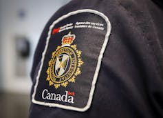 A shoulder patch reads Canada Border Services Agency with a gold-coloured ensign in the middle.